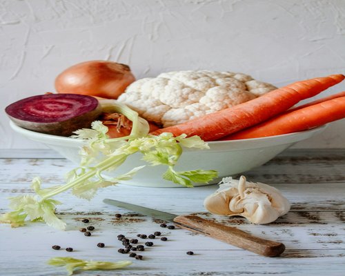 Fresh vegetables and ingredients on a kitchen table